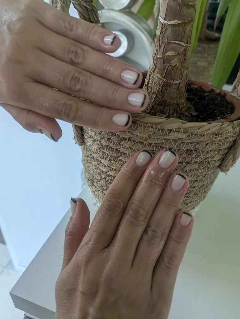 Sophisticated black French manicure nail design at Spawell Complex